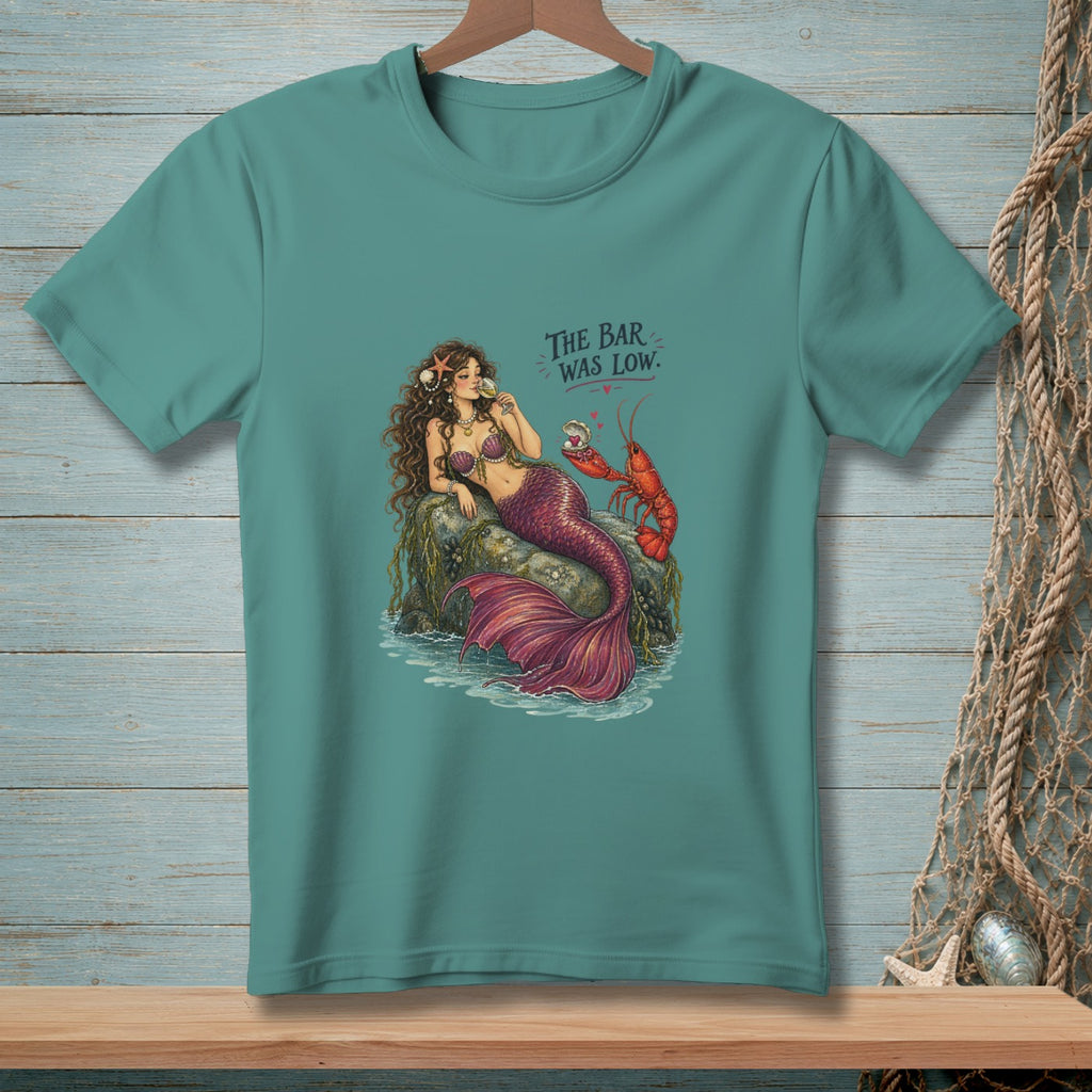 Mermaid on a rock with a lobster holding a pearl, text "The Bar Was Low."