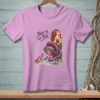 Lilac t-shirt with mermaid, crab, and "Talk to the Tail" text.