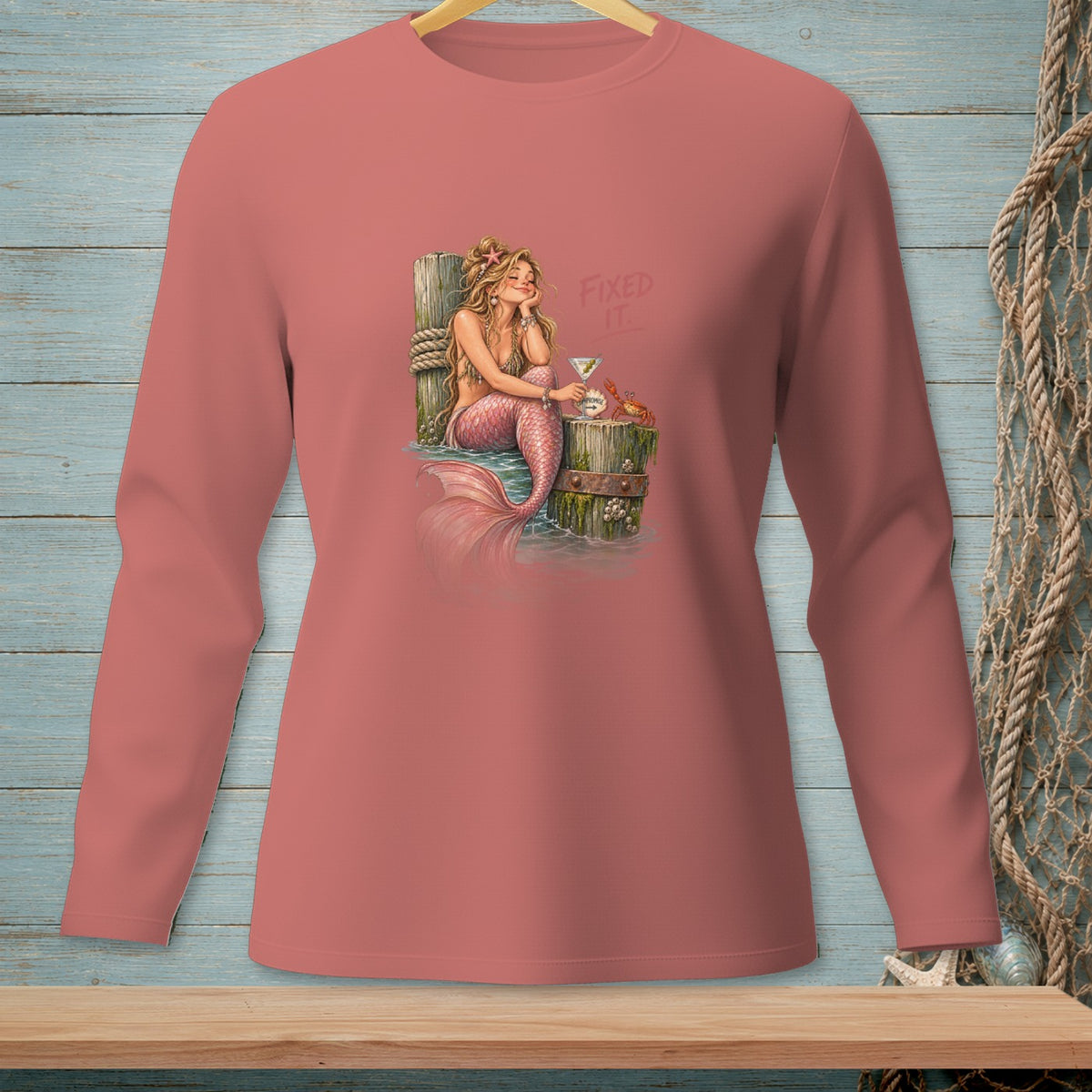 Pink long sleeve shirt with a mermaid, martini, and crab graphic.