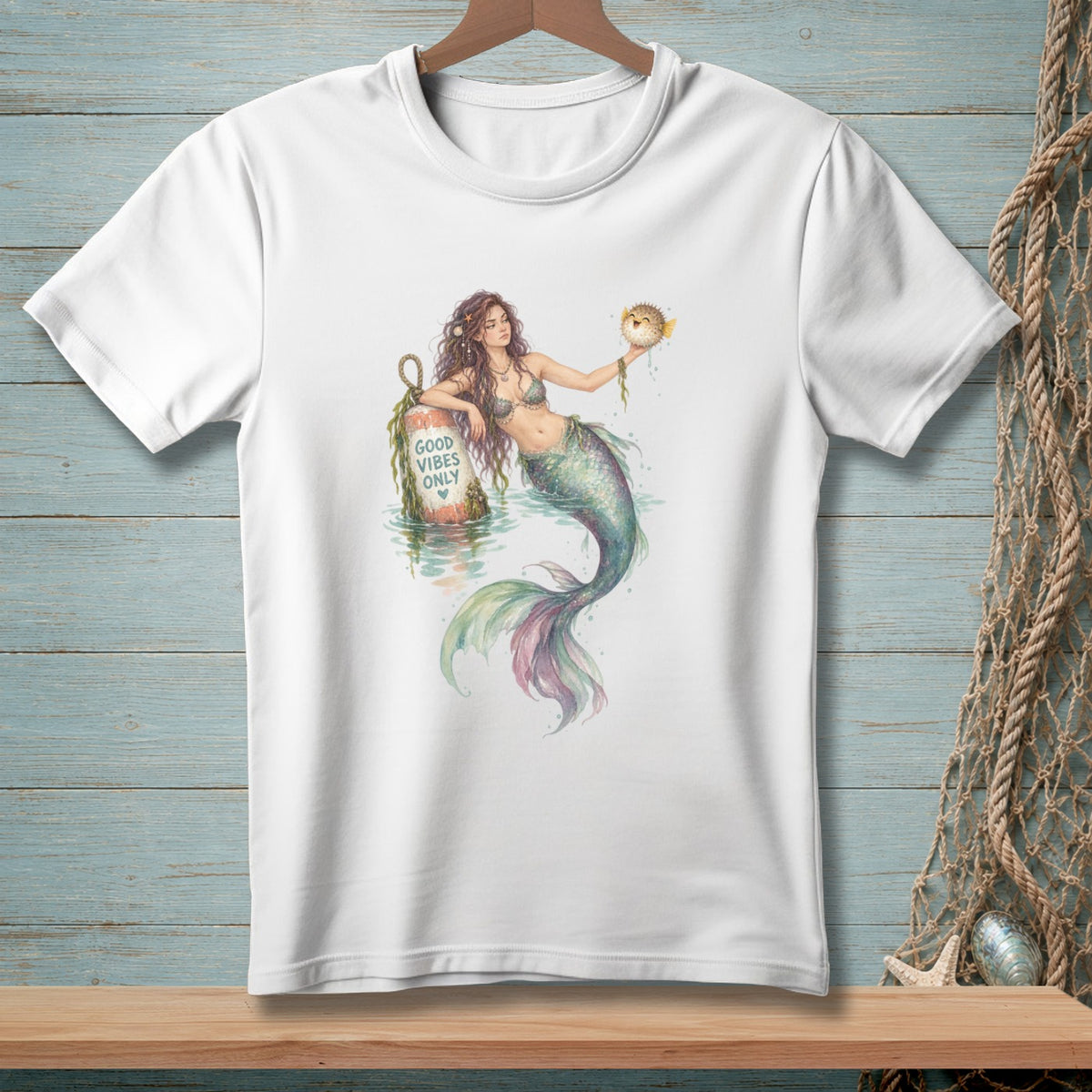Mermaid holding pufferfish near buoy with "Good Vibes Only" text.