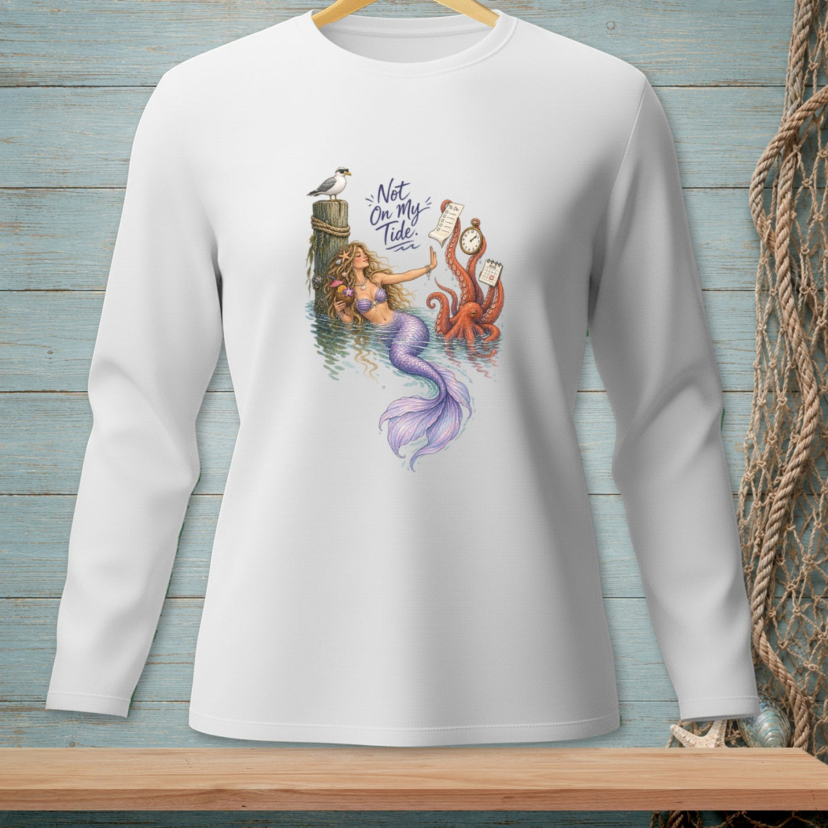 White long-sleeve shirt with mermaid, octopus, seagull, and "Not On My Tide" text graphic.