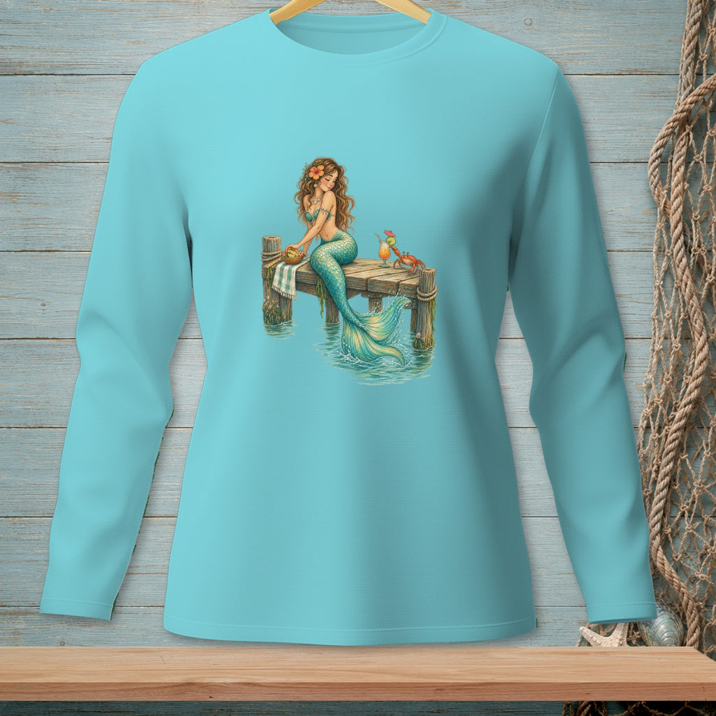 Teal long-sleeve shirt with a graphic of a mermaid sitting on a dock with drinks and a crab.