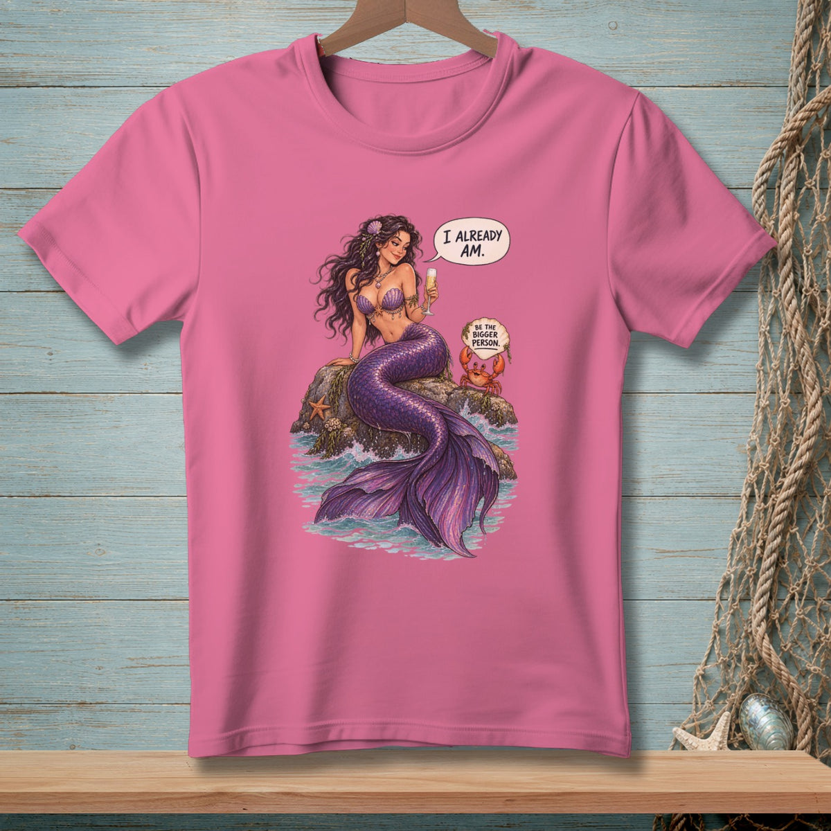 Pink t-shirt featuring a mermaid with a speech bubble saying "I already am."