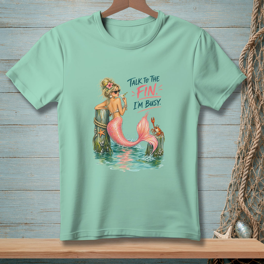 Mint green t-shirt graphic of a mermaid saying "Talk to the fin. I'm busy."