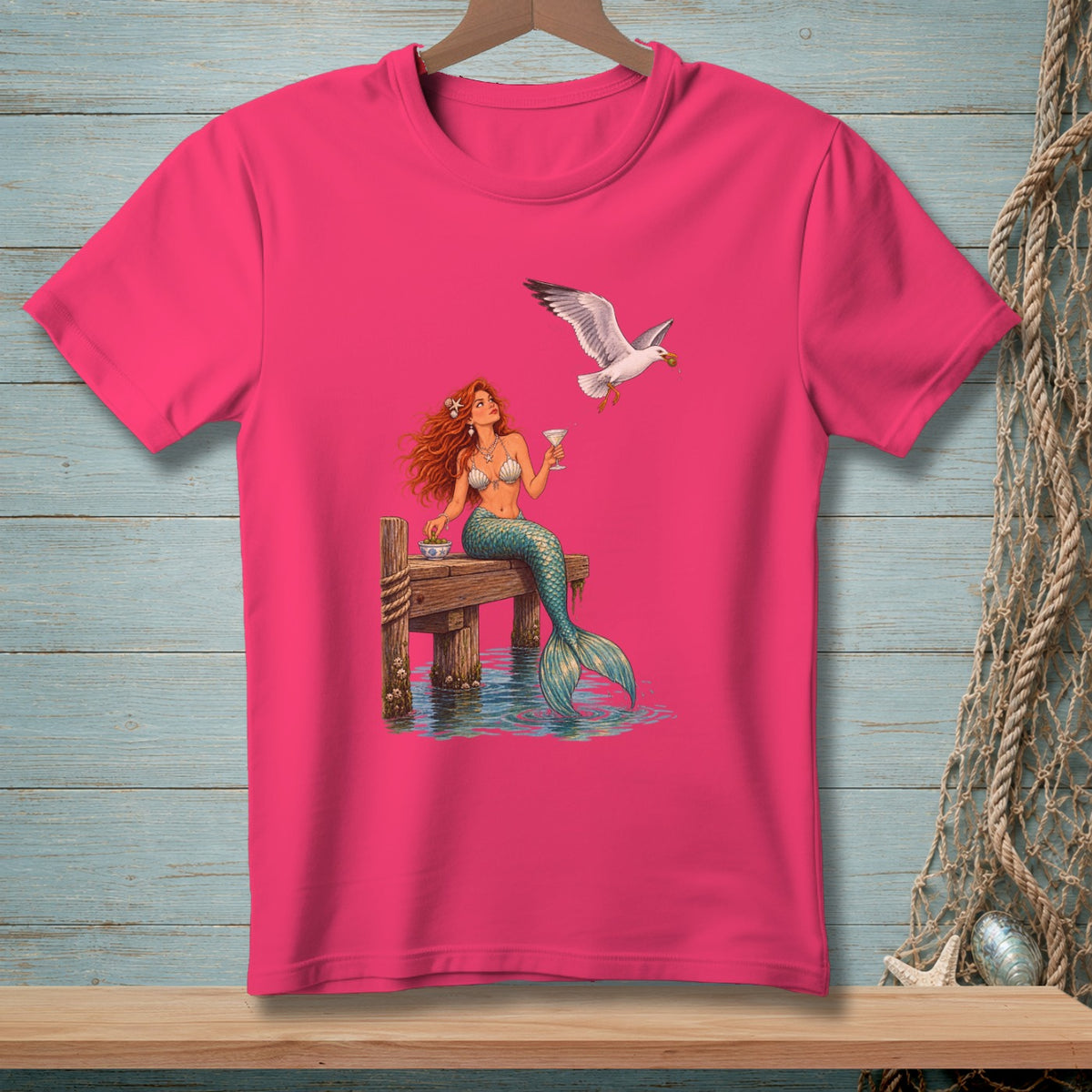 Mermaid with cocktail and food sitting on dock with a seagull.
