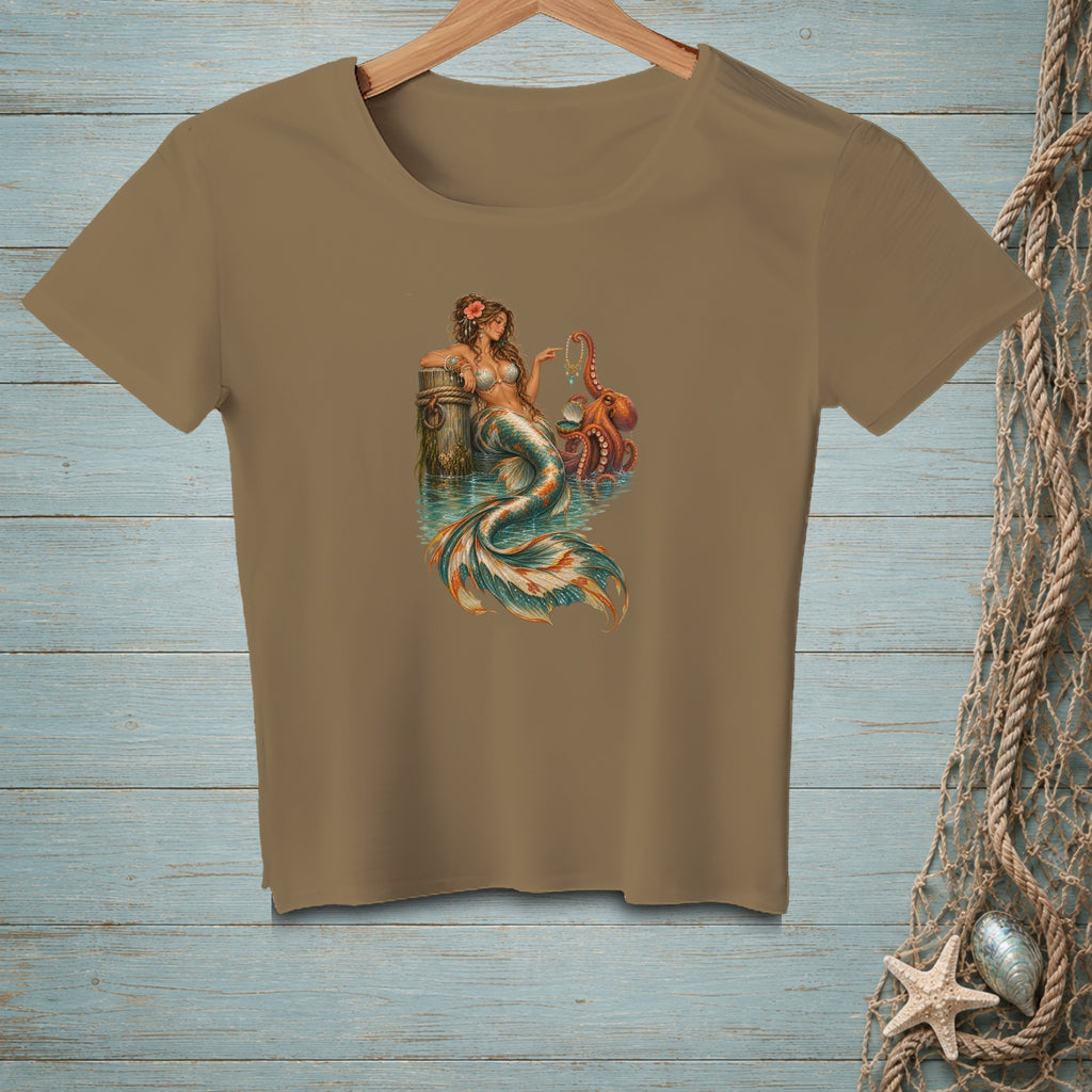 T-shirt with mermaid and octopus design on a wooden background.