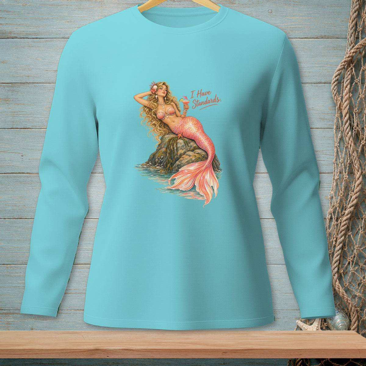 Turquoise long-sleeve shirt with mermaid graphic and text "I Have Standards."