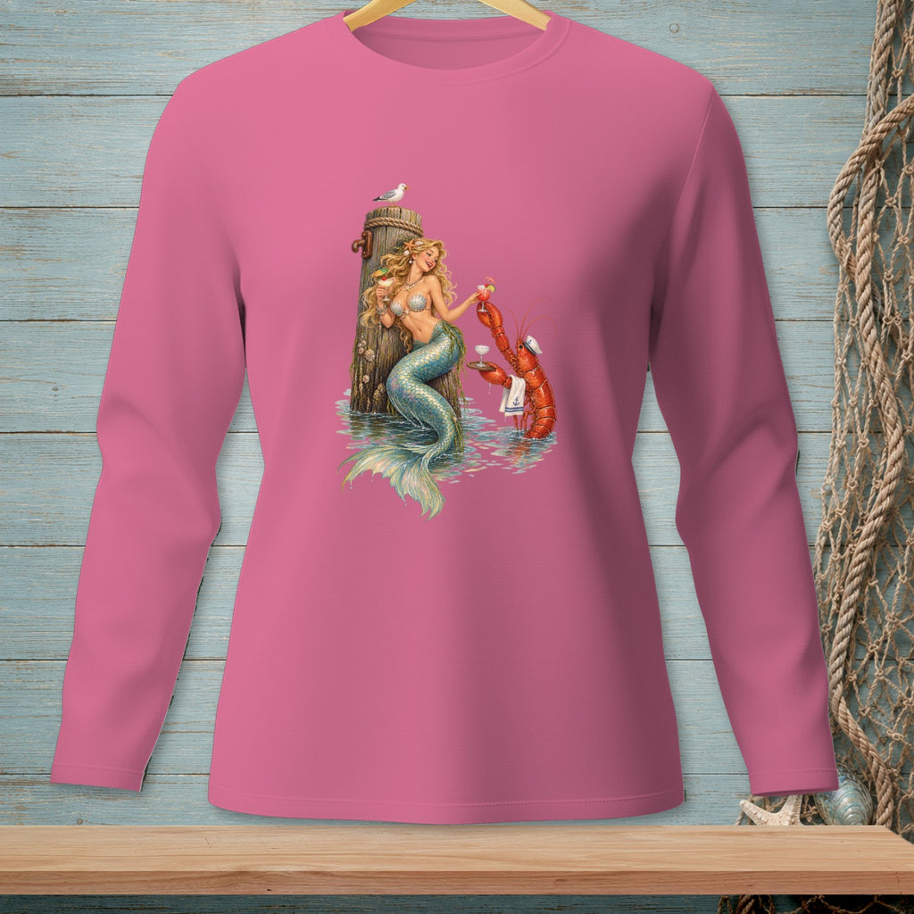 Pink long-sleeve shirt featuring a mermaid and lobster with drinks on a wooden post.