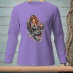 Mermaid sitting on a pier with flowers and sunglasses, on a purple long-sleeve shirt.