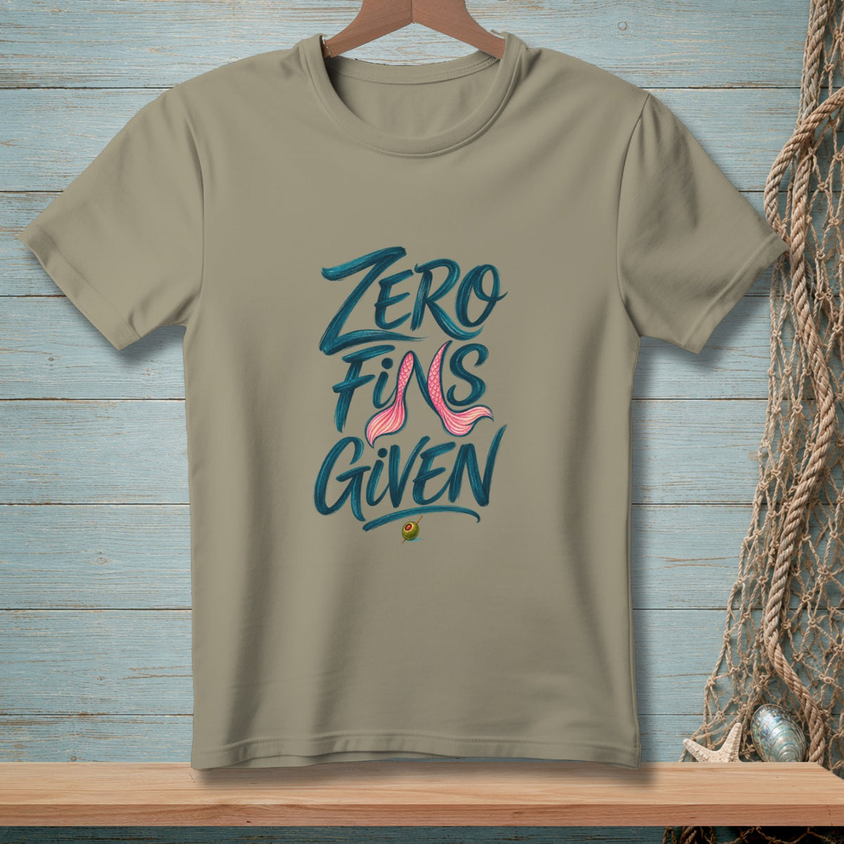 Tan t-shirt with "ZERO FINS GIVEN" text and pink mermaid tail.