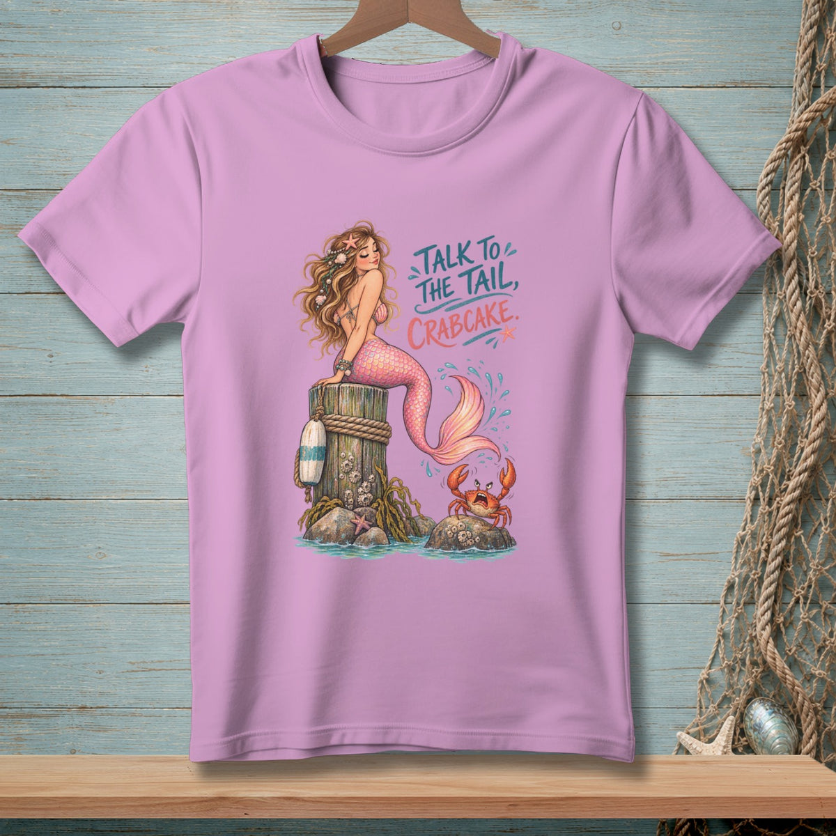 Mermaid sitting on post with crab, text "Talk to the tail, crabcake".