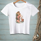 White t-shirt with a mermaid and octopus graphic on a wooden post.