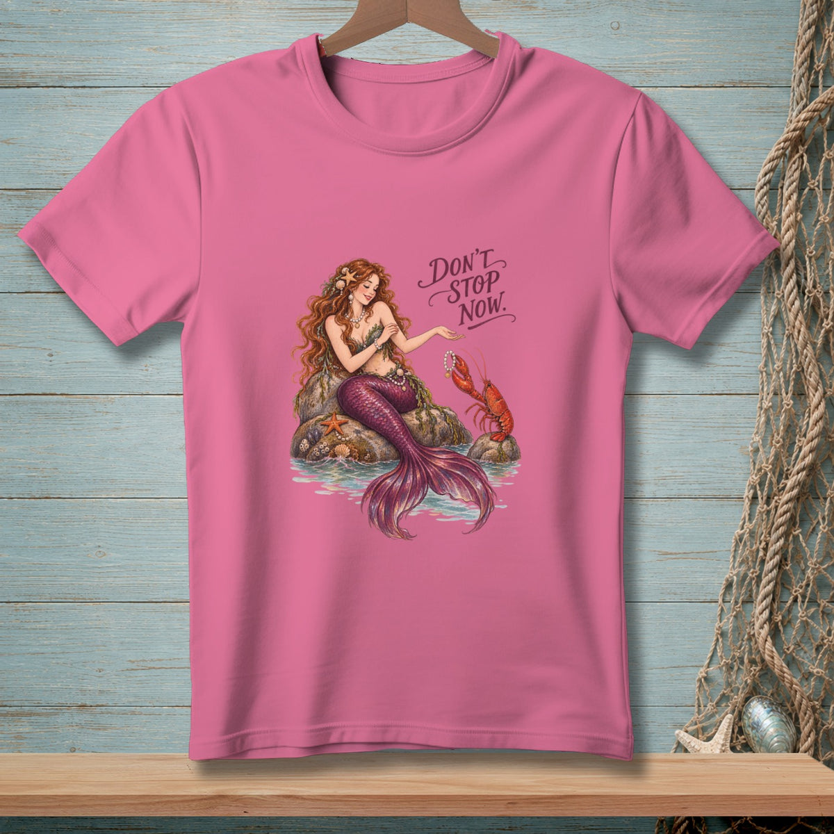 Pink t-shirt with a mermaid, lobster, starfish, and text "Don't Stop Now."