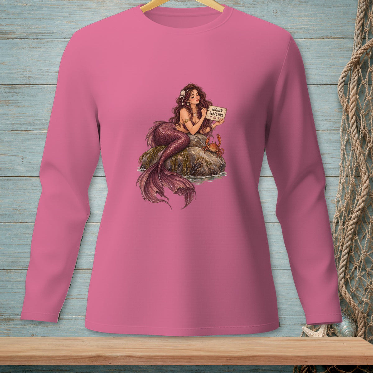 Pink long-sleeve shirt with a mermaid holding a "HIGHLY SELECTIVE" sign.