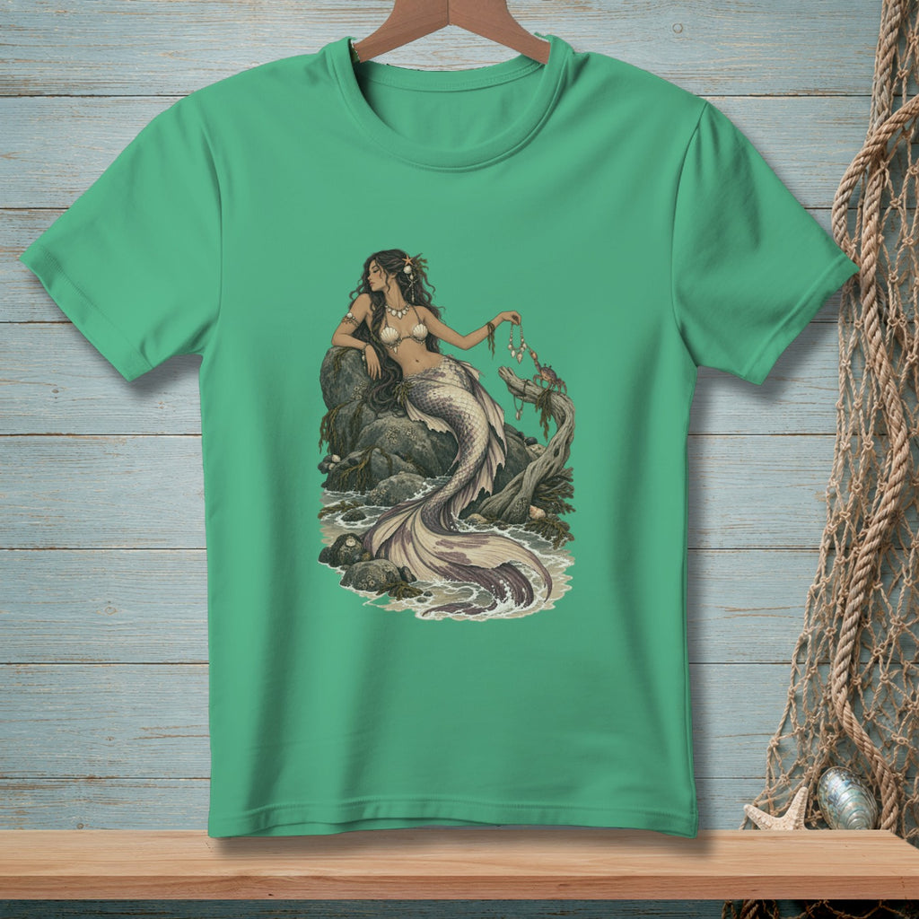 Mermaid with seashell bra sitting on rocks by the ocean with crabs and turtles.