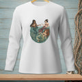 Three mermaids in a bowl of water with seaweed and seashells.