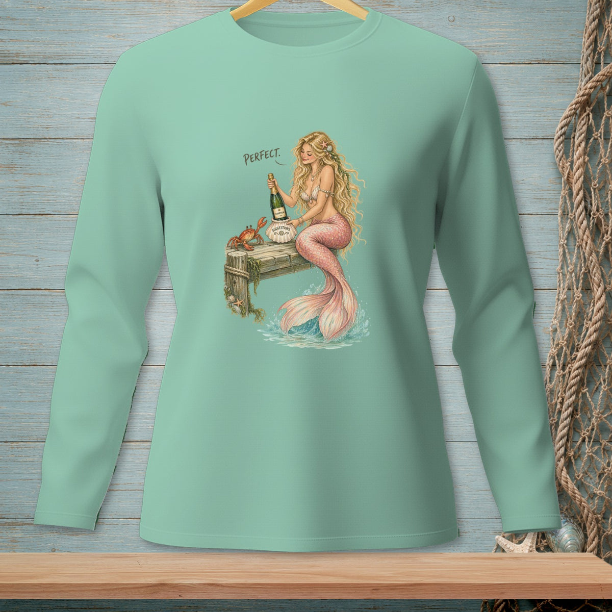 Mermaid with champagne and crab on pier, with the word "PERFECT."