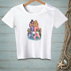 White t-shirt with graphic of two mermaids on a dock sharing a phone.