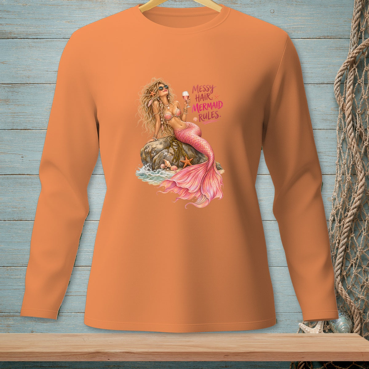 Long sleeve orange shirt with a mermaid graphic and text "Messy Hair Mermaid Rules."