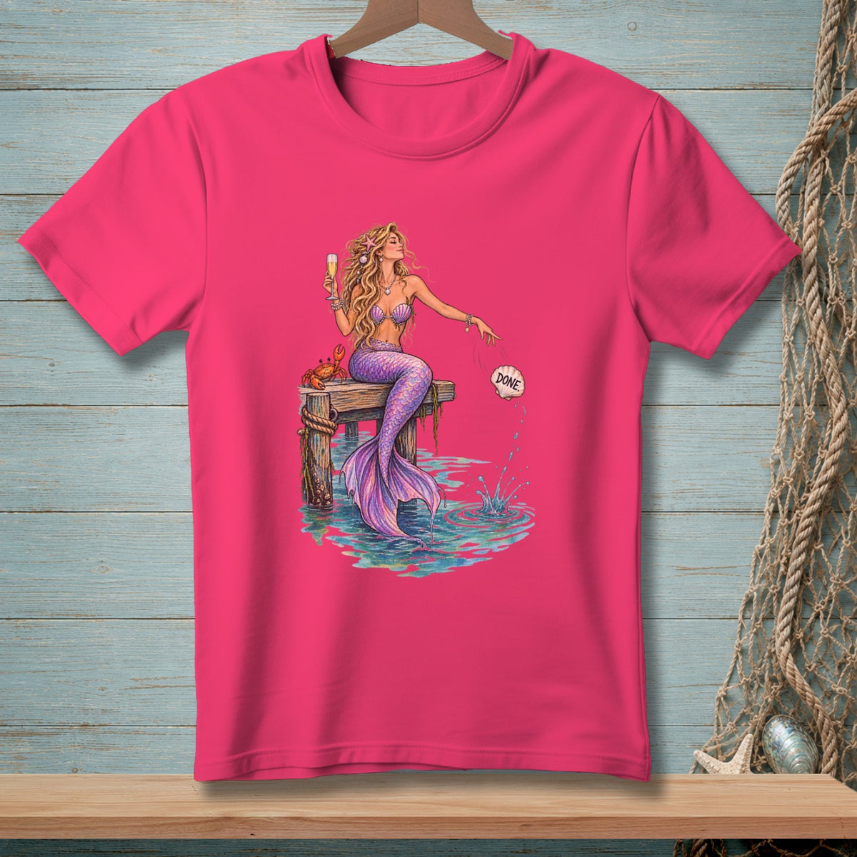 Pink t-shirt with mermaid sitting on dock holding champagne, crab, and saying "DONE".