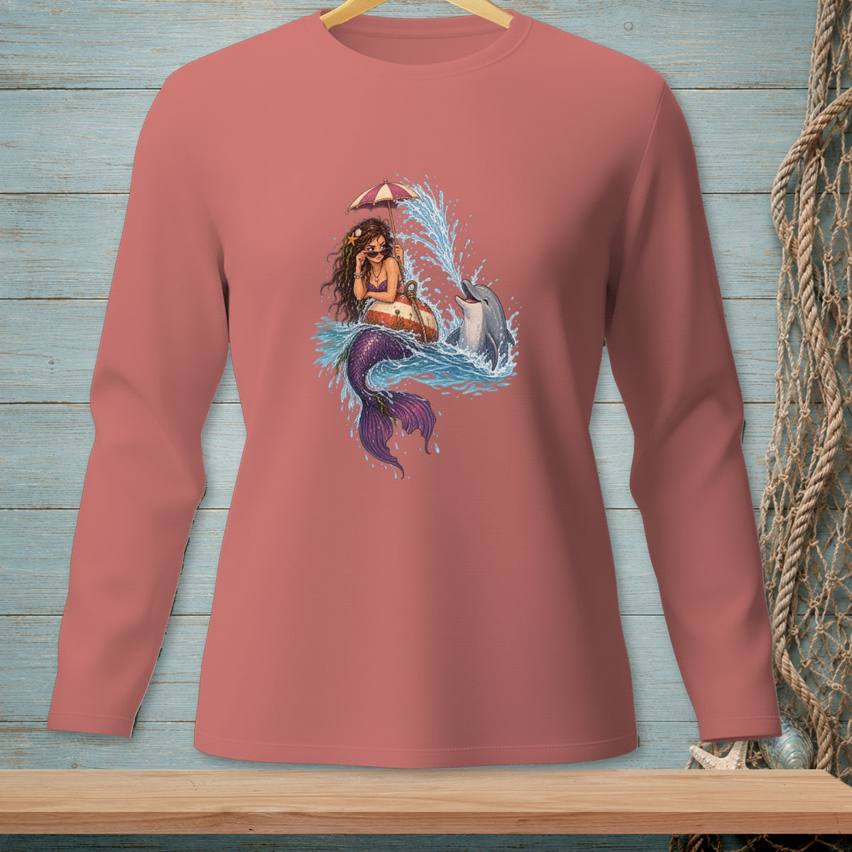 Mermaid holding umbrella and dolphin splashing in the water.