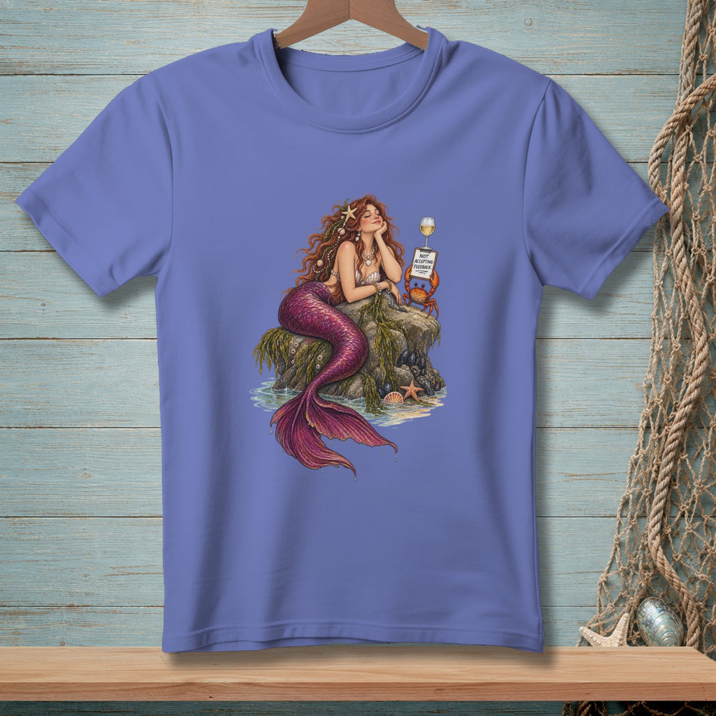 Purple t-shirt with a drawing of a mermaid resting on a rock next to a crab and wine.