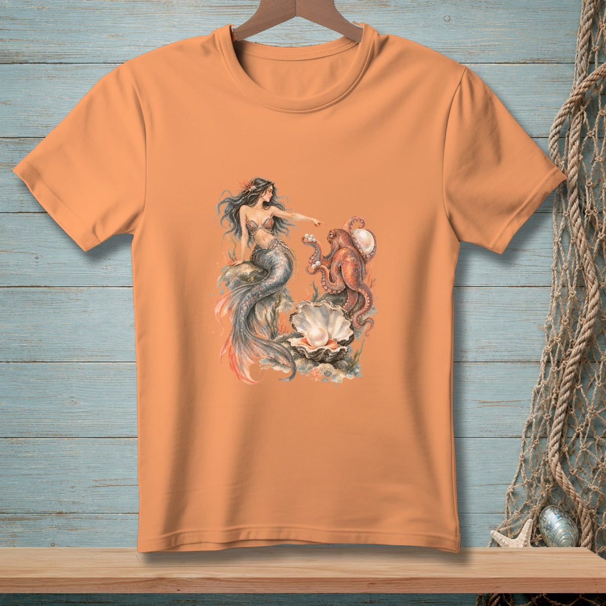 Mermaid and octopus graphic with pearl on an orange t-shirt.