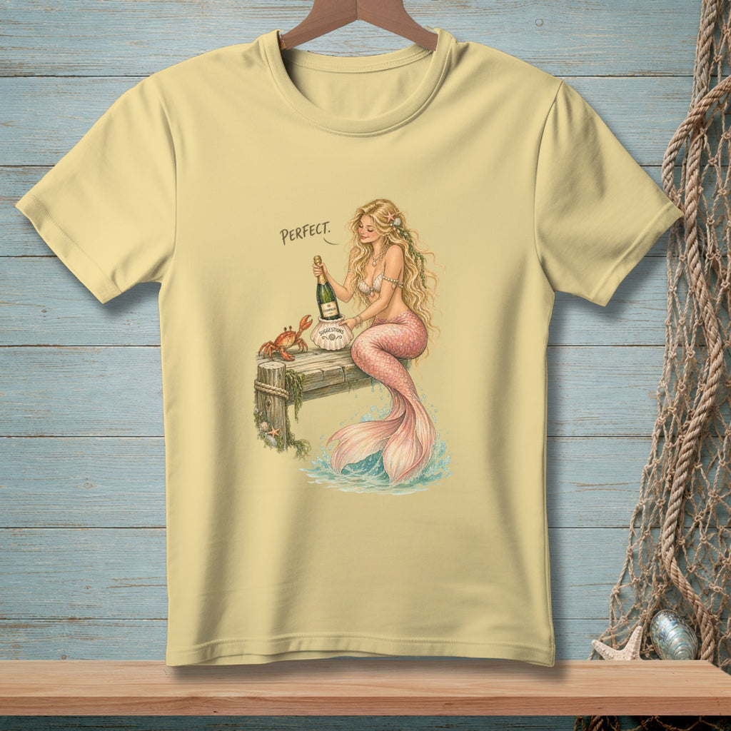 A mermaid holds champagne on a pier with a crab, the word "Perfect" is above.