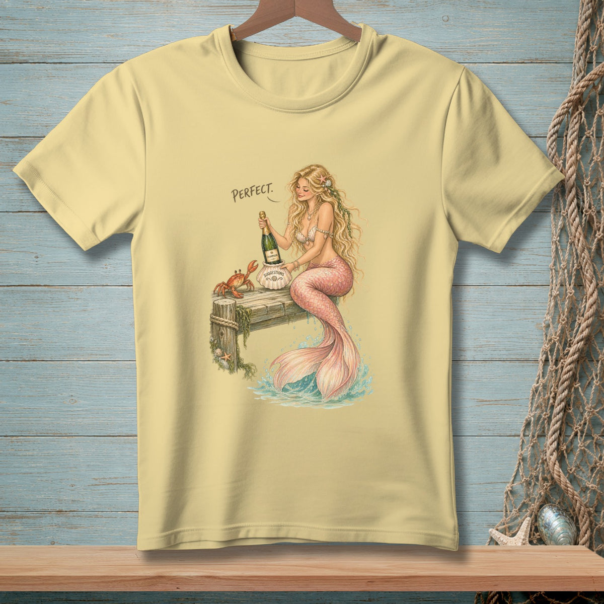 A mermaid holds champagne on a pier with a crab, the word "Perfect" is above.