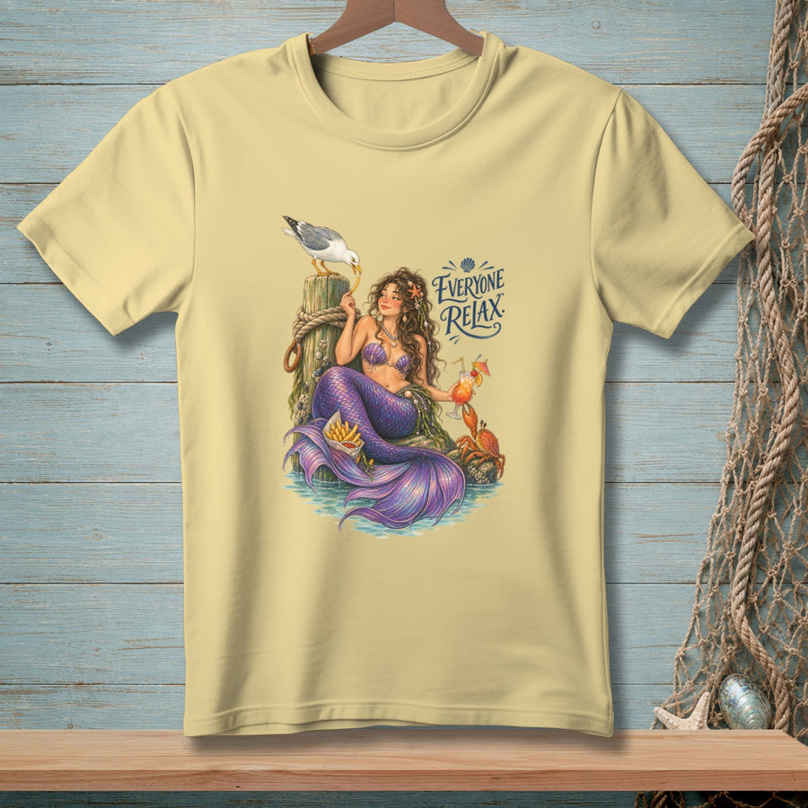 Light yellow t-shirt with a mermaid, seagull, crab, french fries, and cocktail with text "Everyone Relax".