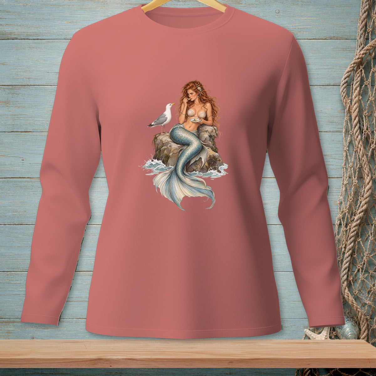 Long-sleeve shirt with a mermaid and seagull on a rock graphic.