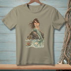 T-shirt graphic of a mermaid sitting on rocks with a crab in the ocean.