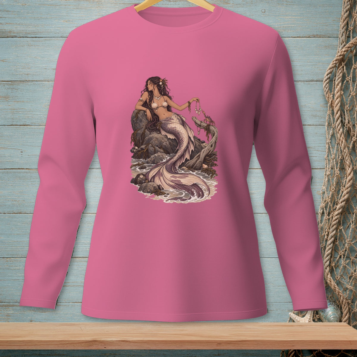 Long-sleeve pink shirt with a detailed illustration of a mermaid on a rock.