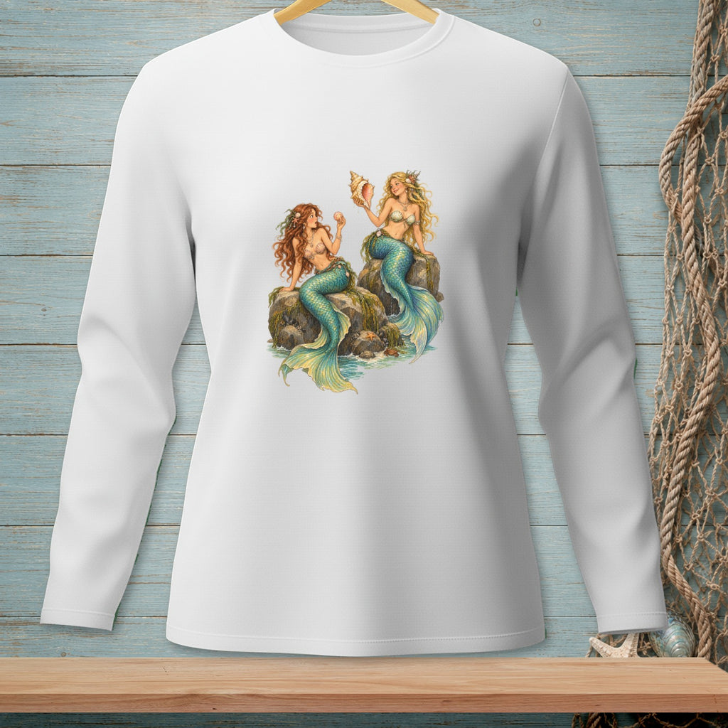 White long-sleeve shirt with two mermaids sitting on rocks with shells and starfish.