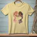 Two mermaids with colorful tails apply makeup around a seashell vanity.
