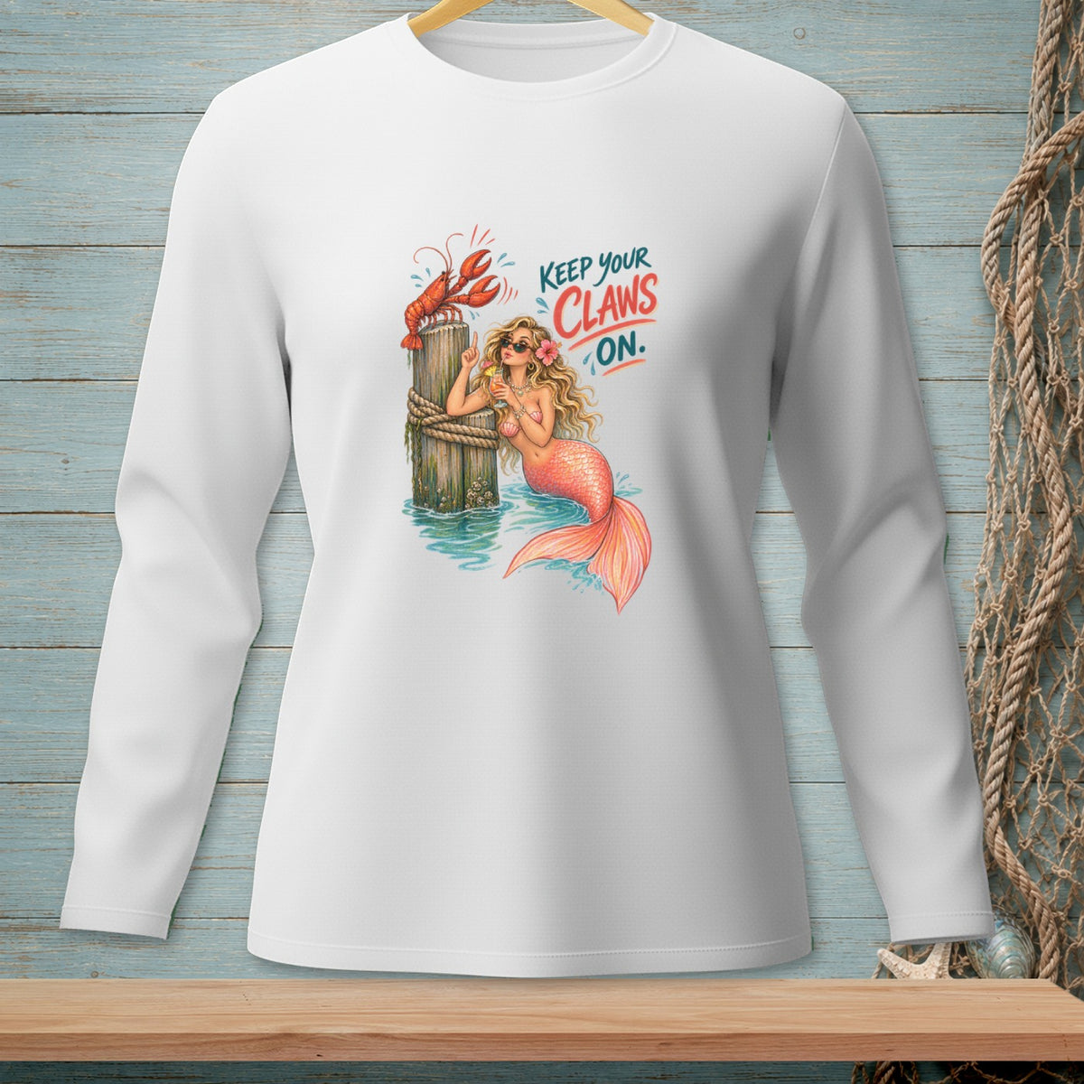 Mermaid with lobster on post, "Keep Your Claws On" text, white long-sleeve shirt graphic.