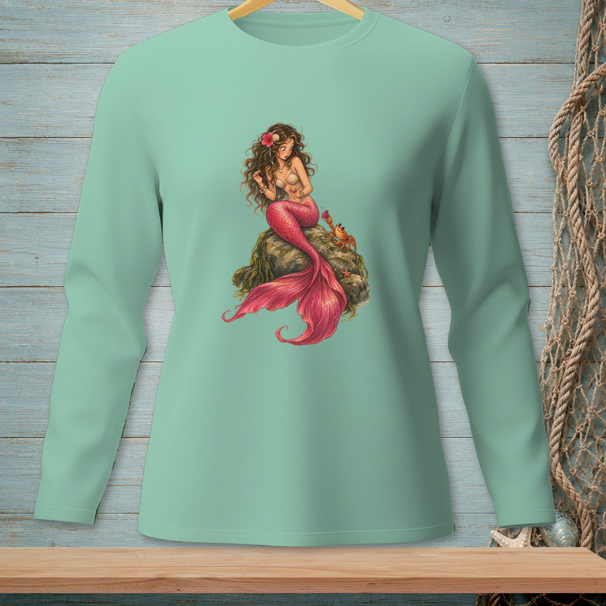 Teal long-sleeve shirt with a mermaid and crab graphic.