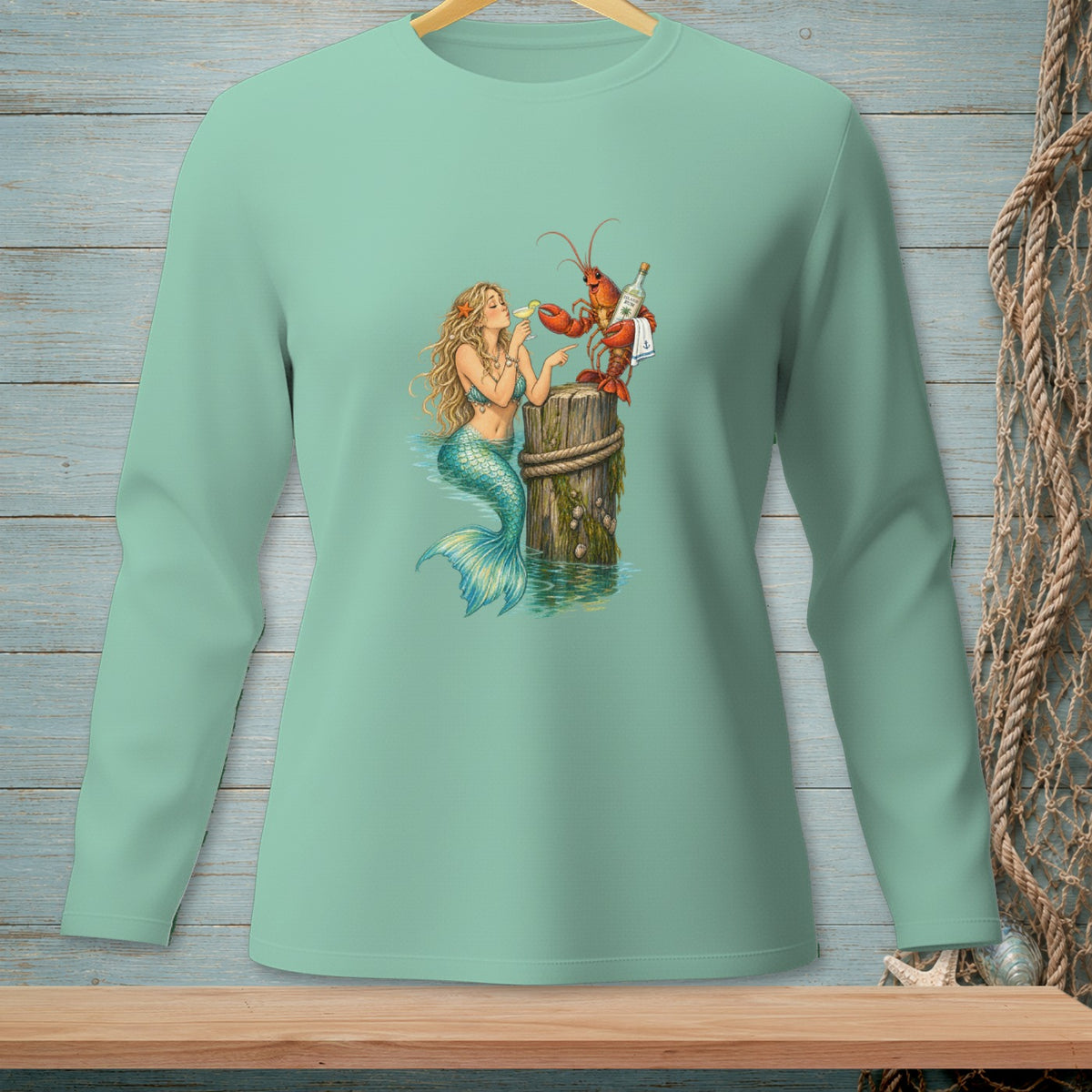 Mermaid and lobster drinking cocktails on a wooden piling in the ocean.