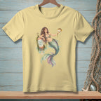 Mermaid with pufferfish and buoy reading "GOOD VIBES ONLY" on yellow t-shirt.