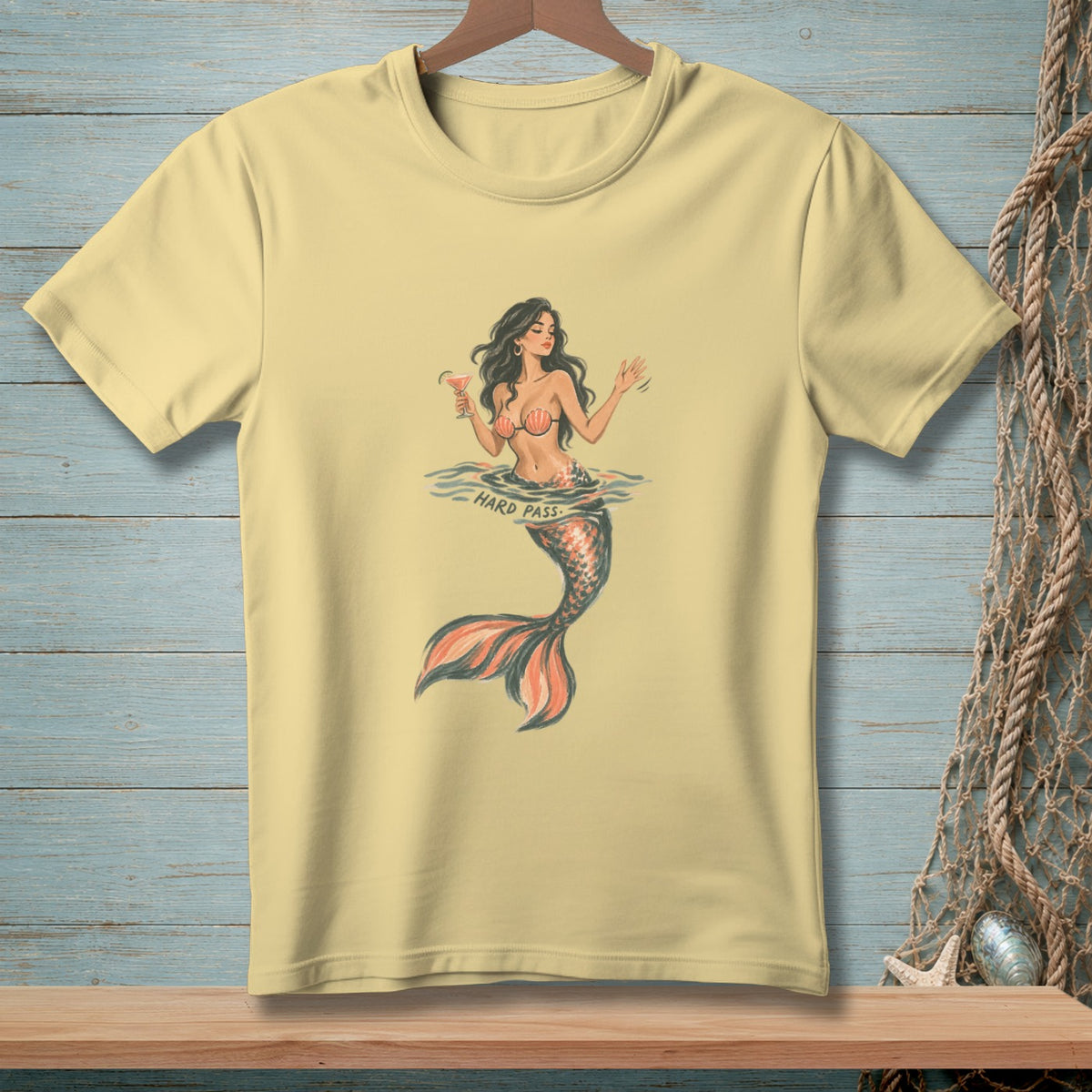 Yellow t-shirt with a mermaid holding a cocktail, text reads "HARD PASS."