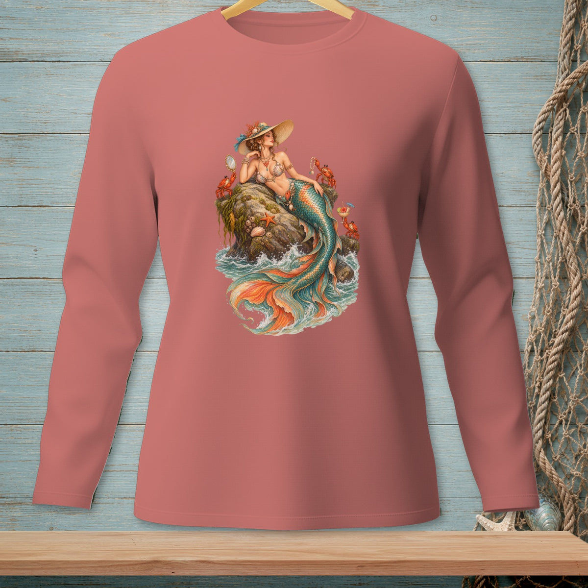 Long-sleeved shirt with a print of a mermaid sitting on a rock with crabs.