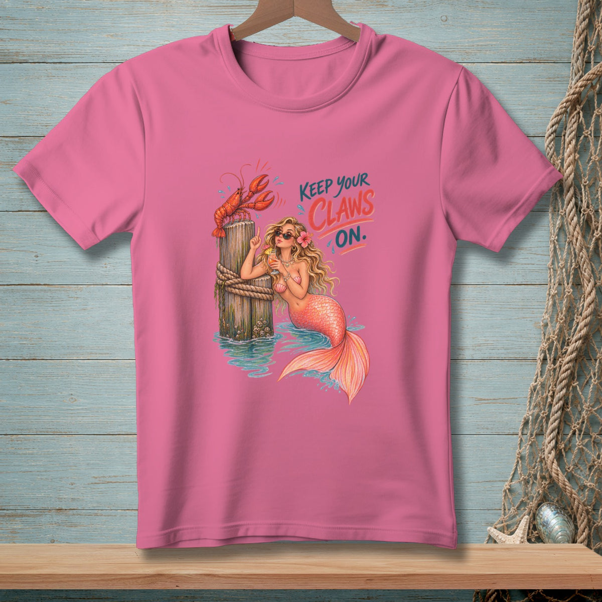Pink t-shirt with mermaid, lobster, and text "Keep Your Claws On".