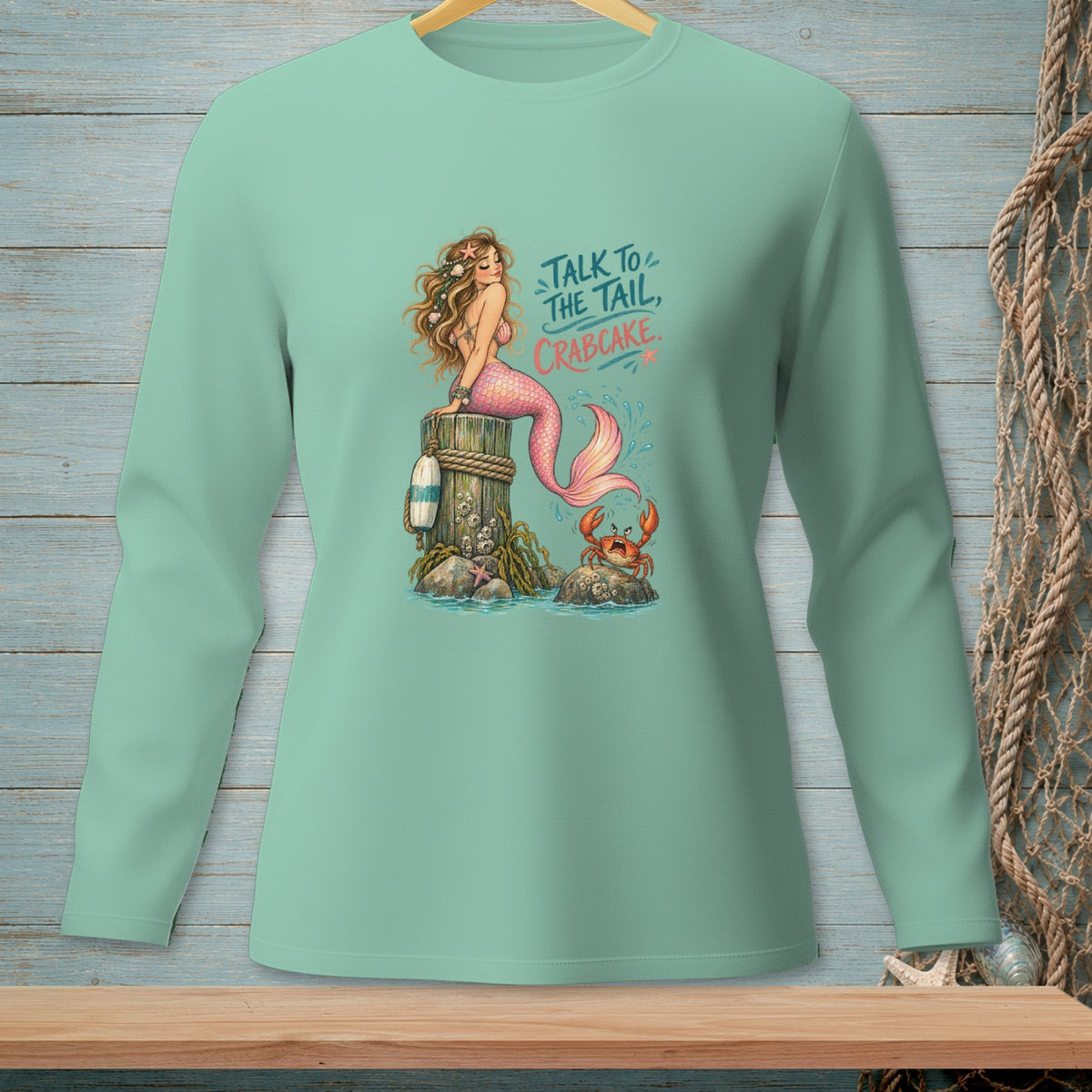 Mermaid with crab on post, with text "Talk to the tail, crabcake."
