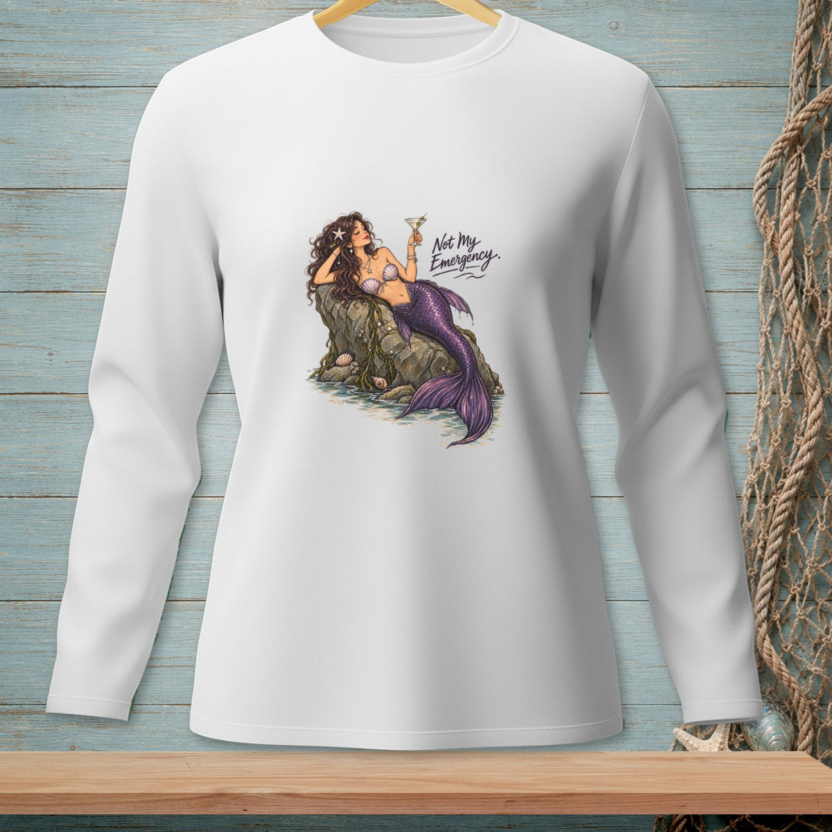 Mermaid relaxing on a rock with a drink, text reads "Not My Emergency."