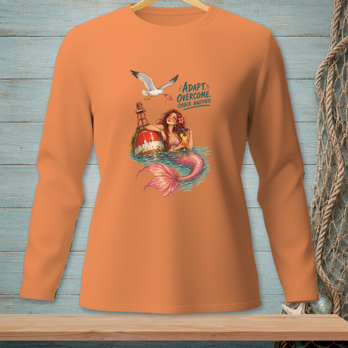 Orange long-sleeve shirt with mermaid, buoy, and text "ADAPT. OVERCOME. ORDER ANOTHER."
