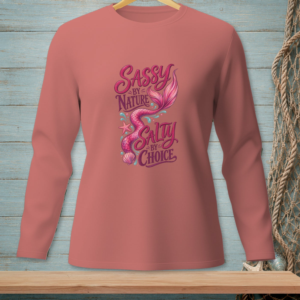 Coral long-sleeve shirt with mermaid and "Sassy by Nature Salty by Choice" text.