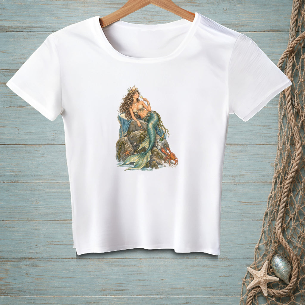 White t-shirt with a mermaid illustration sitting on rocks with a crab and starfish.