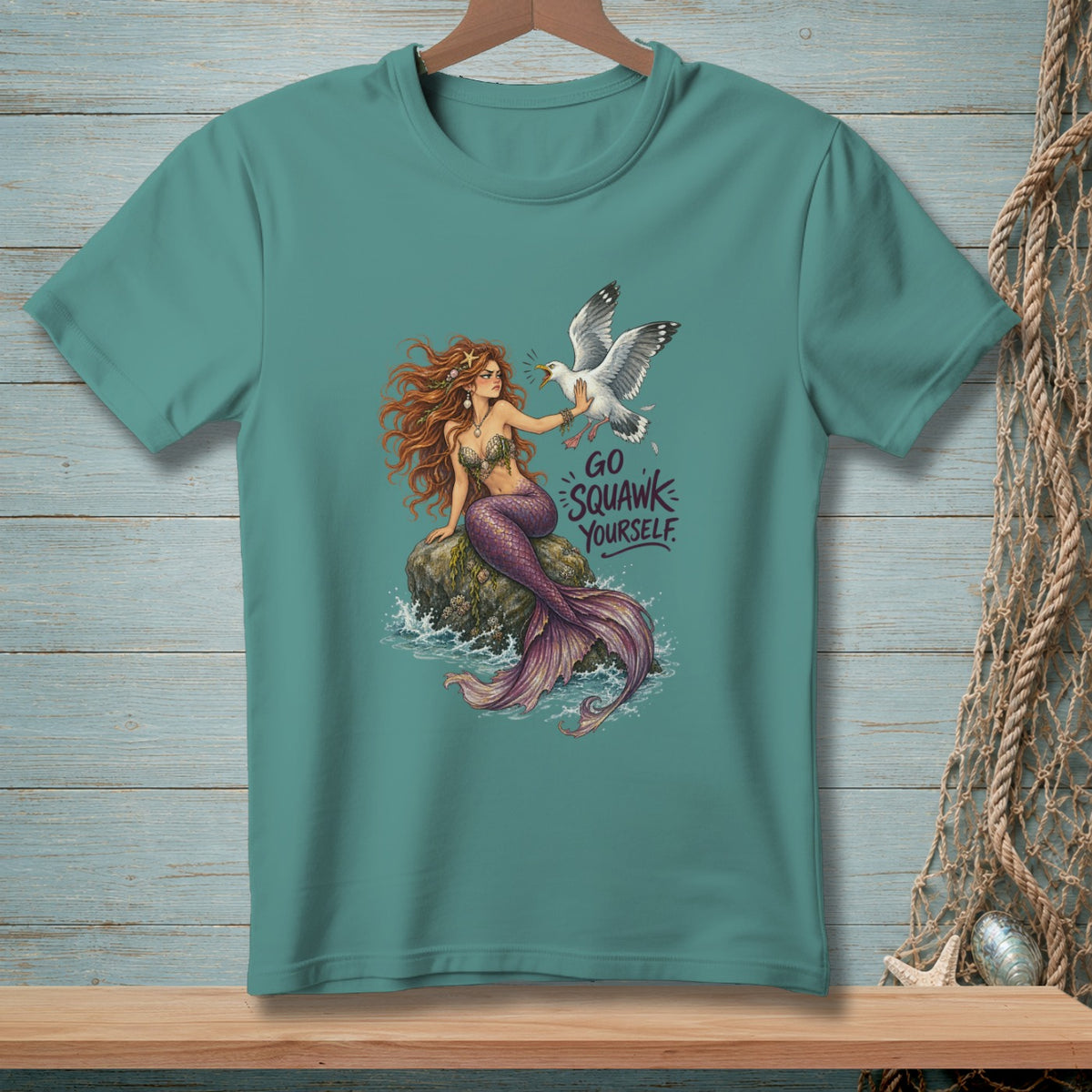 Mermaid sitting on rock with seagull and text "GO SQUAWK YOURSELF."