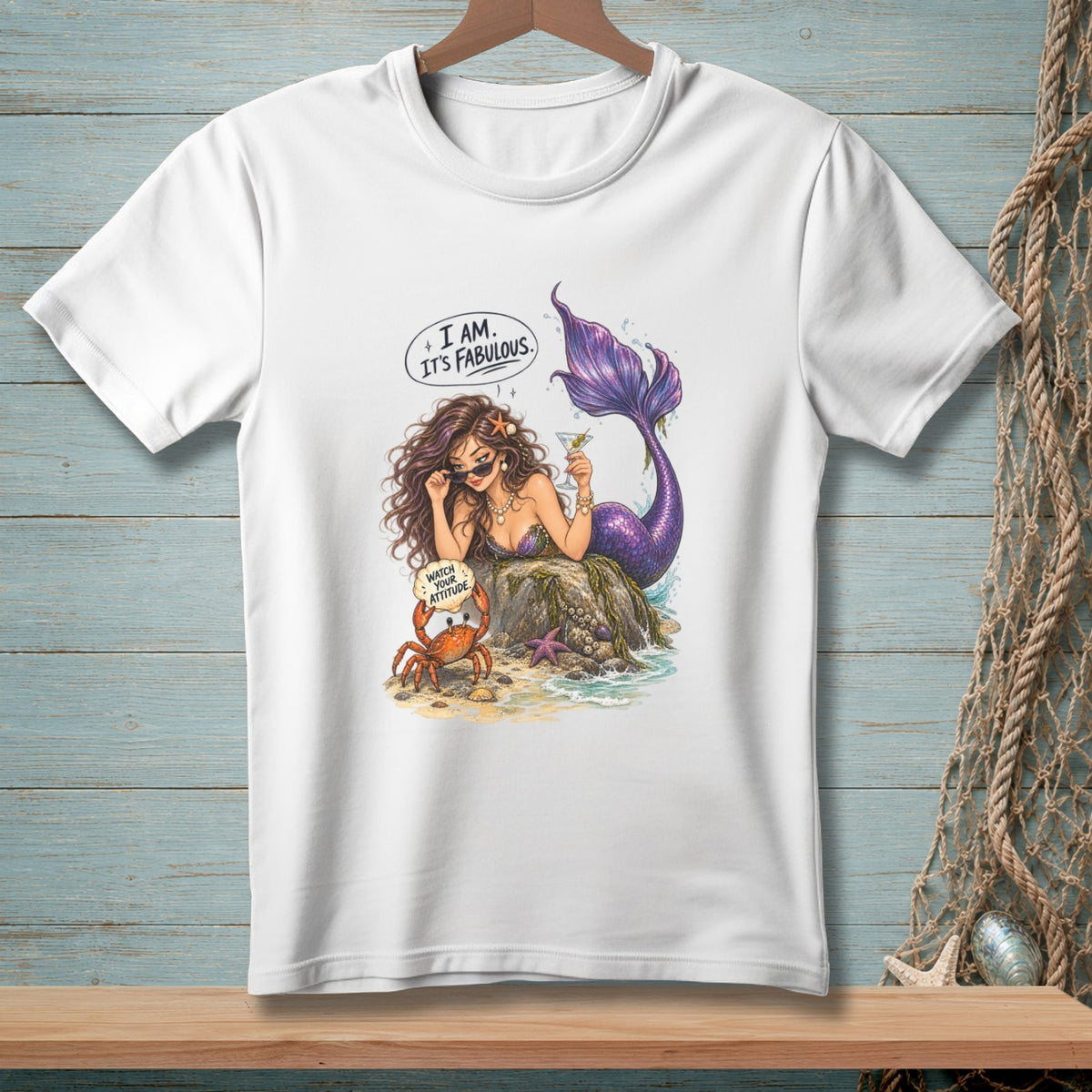 Mermaid with purple tail holding a drink, speech bubble "I AM. IT'S FABULOUS.", crab with "WATCH YOUR ATTITUDE."