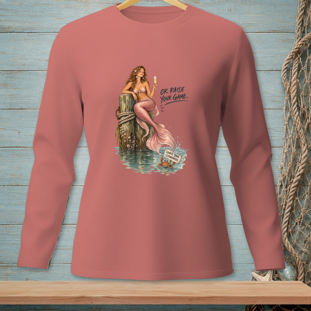 Mermaid holding champagne, text "OR RAISE YOUR GAME" and "LOWER YOUR STANDARDS".